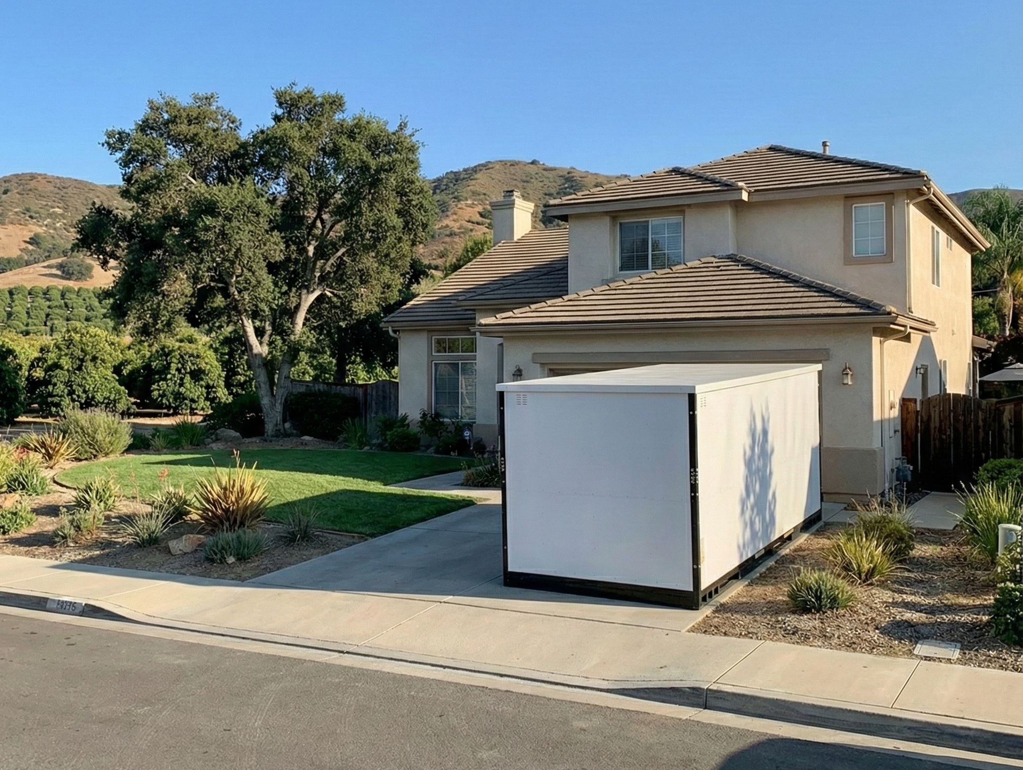 a portable storage in oxnard container sitting in the driveway of a large two story home waiting to be loaded for a remodel